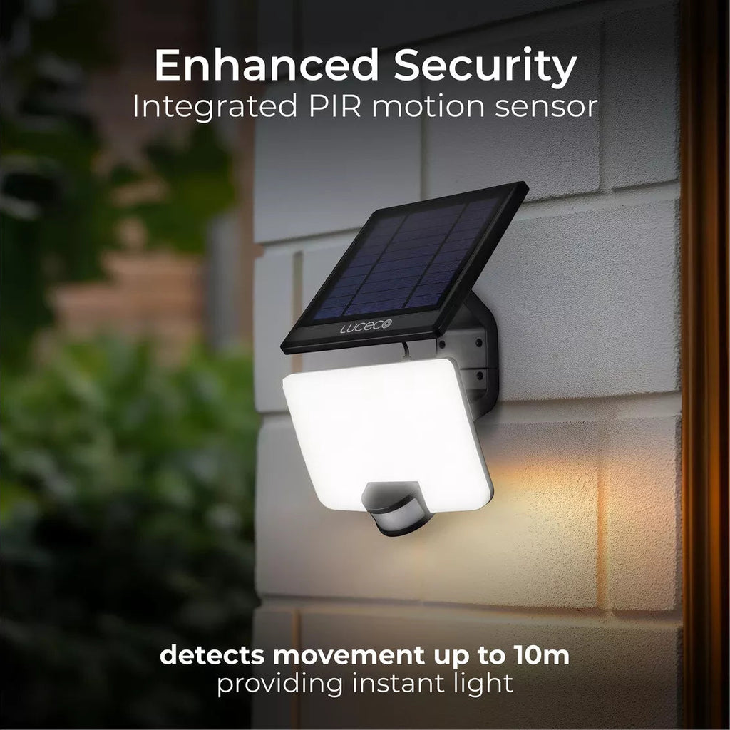 Solar-powered outdoor security light with motion sensor on a house wall.