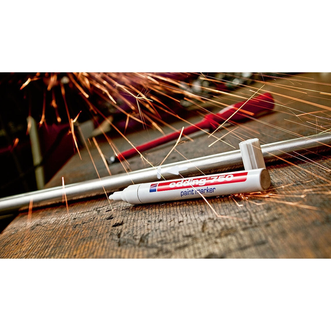 Paint marker with sparks on a wooden surface