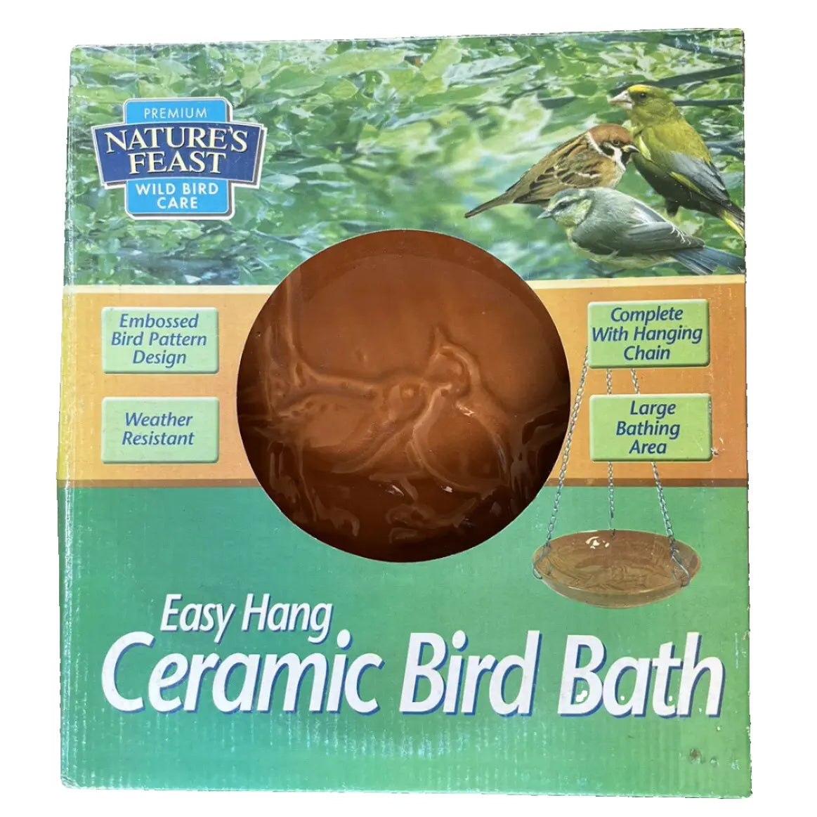 A brown ceramic bird bath with an embossed bird pattern, designed to be hung using a galvanised chain, displayed in its packaging which highlights features such as the large bathing area and weather resistance.