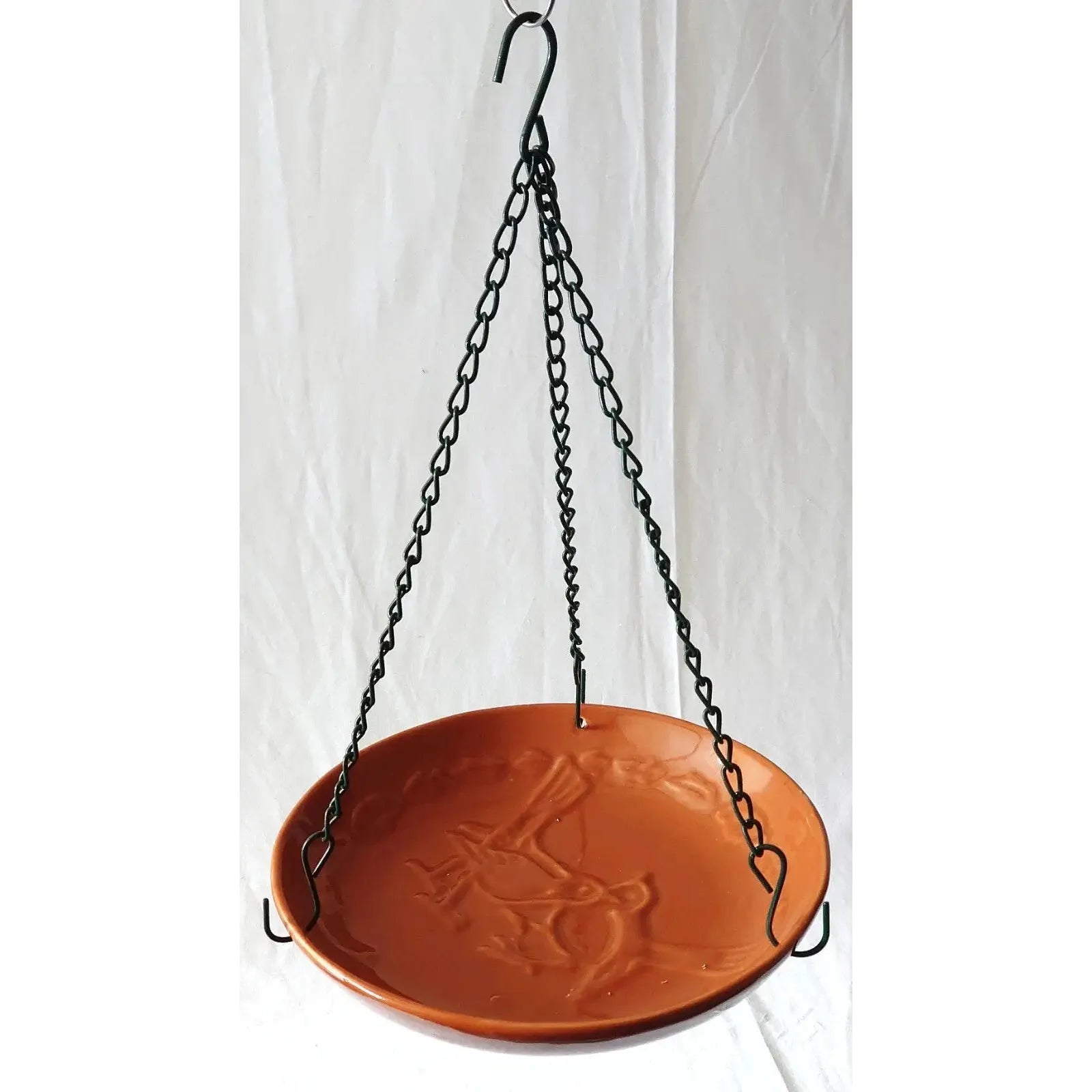 Ceramic bird bath with embossed design on a white background